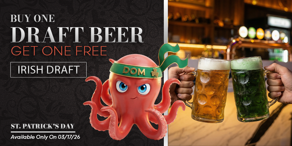 Two hands clinking regular and green draft beers.