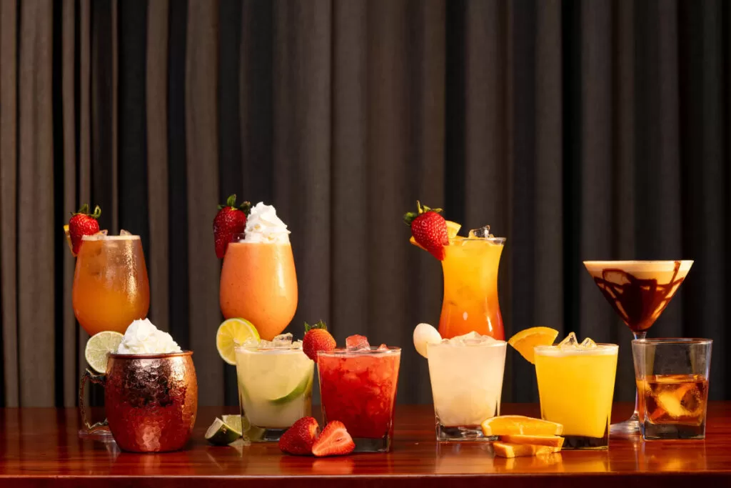 Signature cocktails assortment at Kingdom Sushi featuring colorful, fruit-garnished drinks.